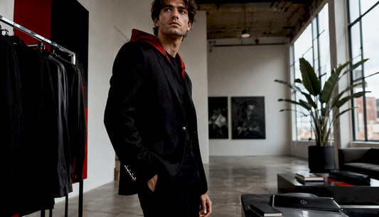 Model showcasing tailored black blazer in atelier