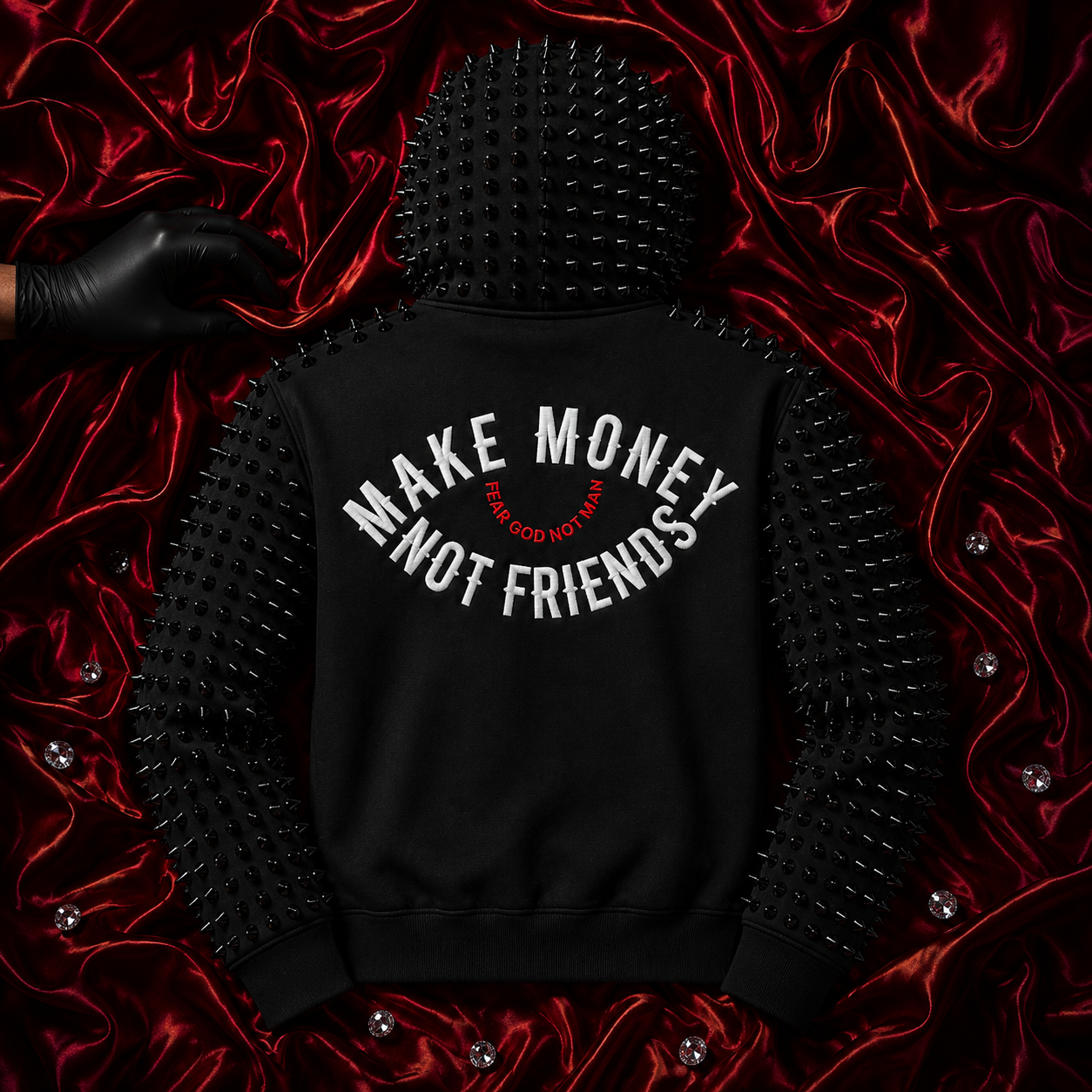 Black hoodie featuring distinctive cone studs on the hood and sleeves, with the phrase "MAKE MONEY NOT FRIENDS" in white on the back.